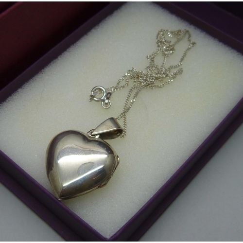 910 - A silver bangle set with a diamond and a silver heart shaped pendant and chain