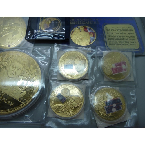 916 - A collection of commemorative and special issue coins, including four Kings oval gold plated coins s... 