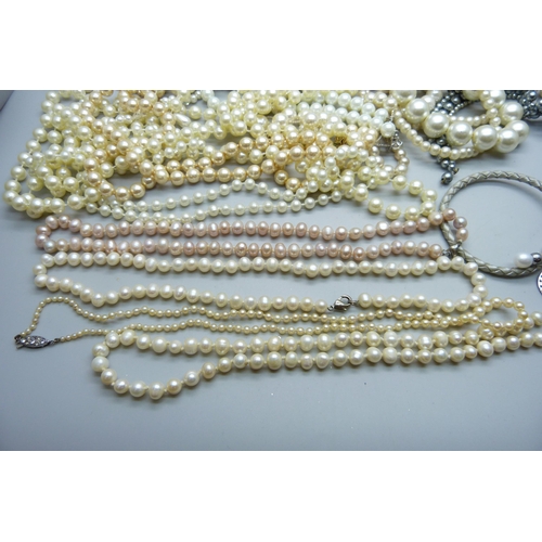 925 - A collection of pearls - four necklaces, two bracelets and a keyring, together with a collection of ... 