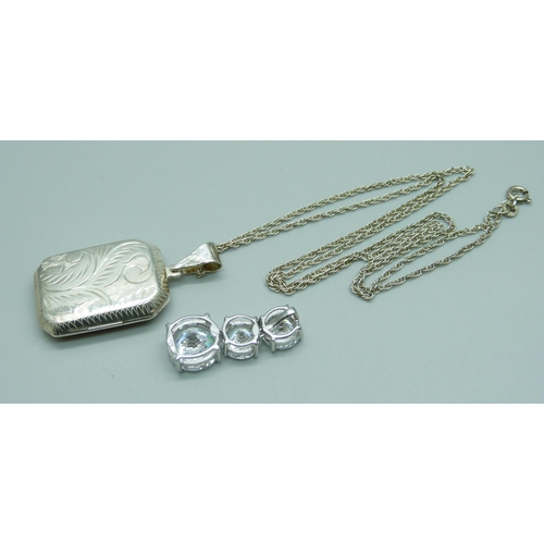 951 - A silver locket and chain and a 925 silver mounted triple white stone articulated pendant