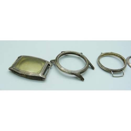 960 - A silver wristwatch case and five bezels