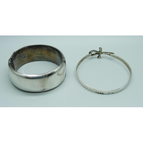 963 - A wide hallmarked silver bangle, 40g, and a continental white metal bangle