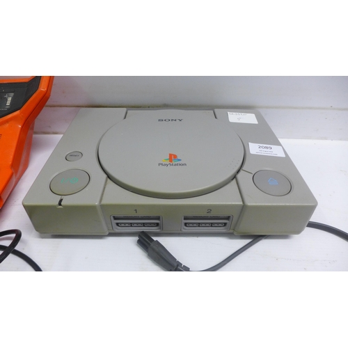 2089 - A Sony PlayStation One console with a PS2 eye toy, a dual shock 2 remote and vintage Bambino basketb... 