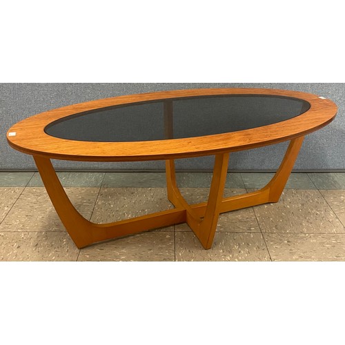 65A - A teak and glass topped oval coffee table