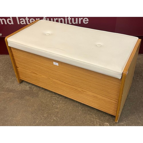 69 - A teak and cream vinyl blanket box