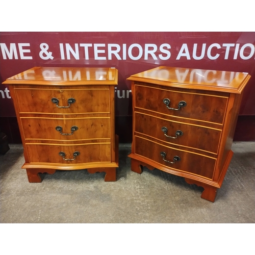 111K - A pair of George III style yew wood serpentine chests of drawers