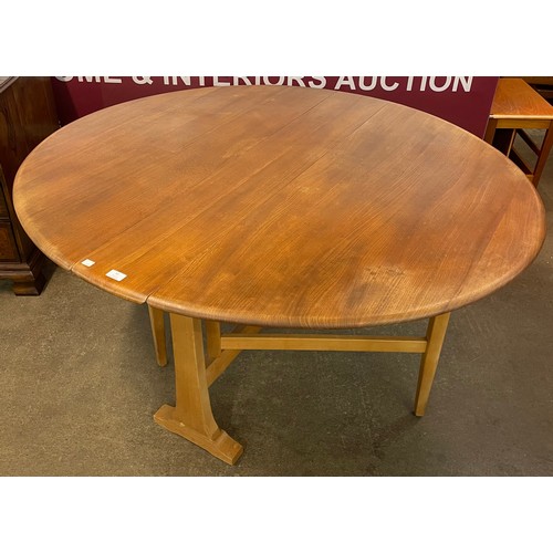 82 - An Ercol Blonde elm and beech Windsor drop leaf table