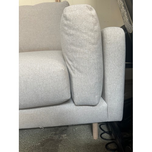 1540 - An oatmeal upholstered three seater sofa - minor damage