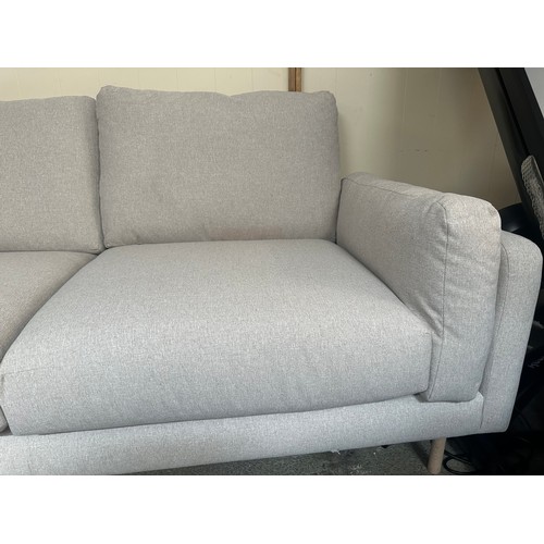 1540 - An oatmeal upholstered three seater sofa - minor damage