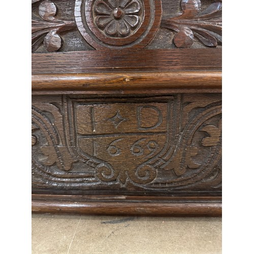 393 - A carved oak pelmet, dated 1669