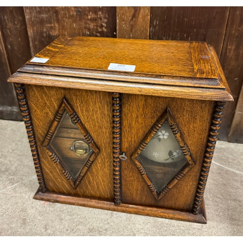 389 - An Edward VII oak smokers cabinet