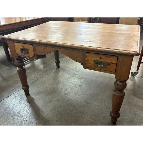 102 - A Victorian pine two drawer writing table