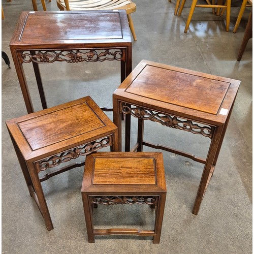 107 - A Chinese carved hardwood nest of quartetto tables