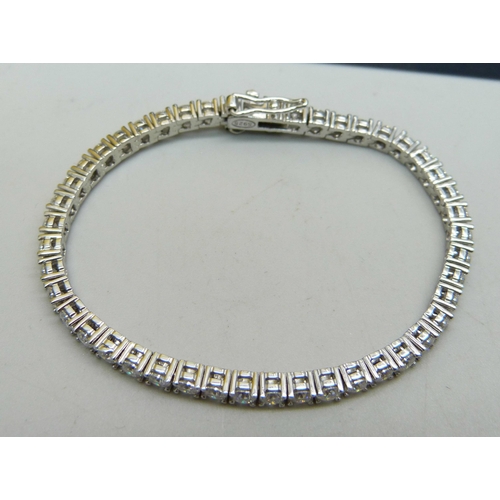 1004 - A silver and moissanite tennis bracelet, with certificate, 15cm