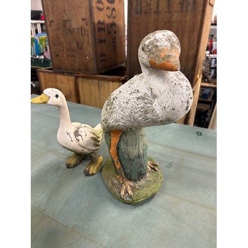 2158 - 2 duck garden ornaments including a duck on a log and one other