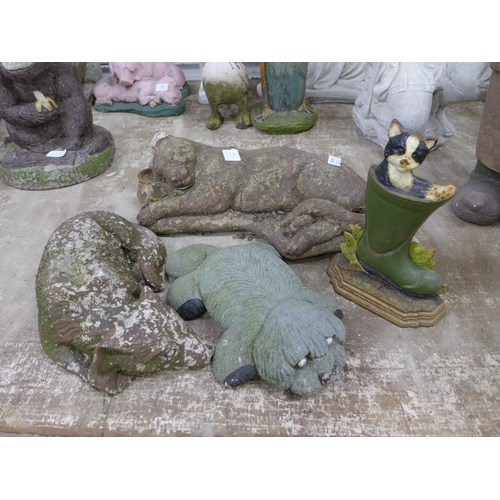 2162 - Concrete garden ornaments including a sleeping cat, a sleeping fox, a dog and a cast metal cat in a ... 