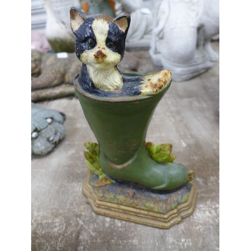 2162 - Concrete garden ornaments including a sleeping cat, a sleeping fox, a dog and a cast metal cat in a ... 