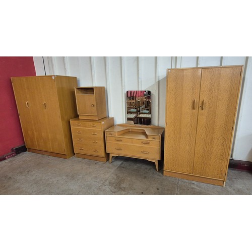 9 - A G-Plan Brandon light oak bedroom suite, comprising; two wardrobes, a chest of drawers, a bedside c... 