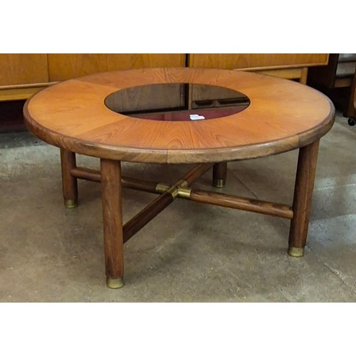 12 - A G-Plan circular teak and glass topped coffee table