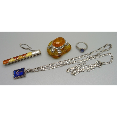 1002 - A silver chain with silver mounted Masonic pendant, a silver ring, a silver and amber clip and a 925... 