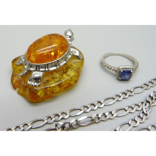 1002 - A silver chain with silver mounted Masonic pendant, a silver ring, a silver and amber clip and a 925... 