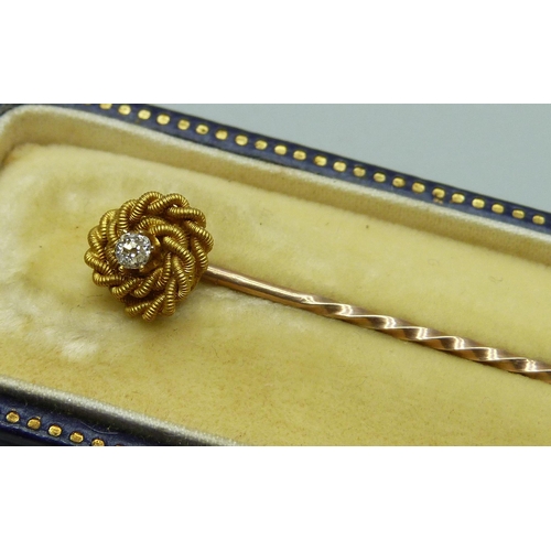 1008 - A diamond set stick pin, marked 15ct, in a fitted case, 1.5g