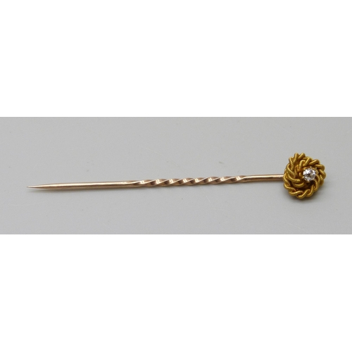 1008 - A diamond set stick pin, marked 15ct, in a fitted case, 1.5g