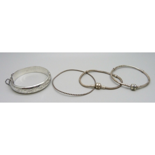 1010 - A hallmarked silver bangle, 18g, two Pandora bracelets and a rope twist bangle