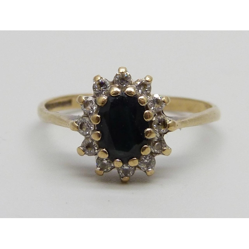 1020 - A 9ct gold sapphire and diamond cluster ring, 1.9g, R