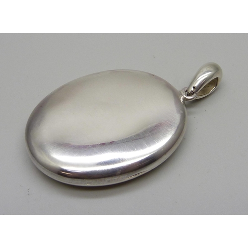 1033 - A large Victorian silver locket, 39mm wide, (not marked, tests silver)