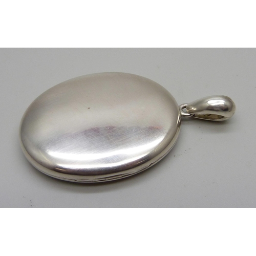 1033 - A large Victorian silver locket, 39mm wide, (not marked, tests silver)