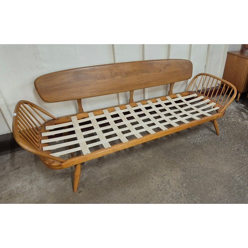 15 - An Ercol Blonde elm and beech 355 model studio couch. Please note this lot is being sold as a work o... 