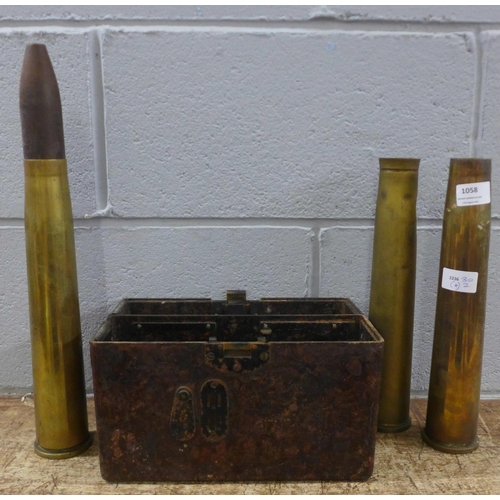 1058 - Three shell cases and a field telephone case