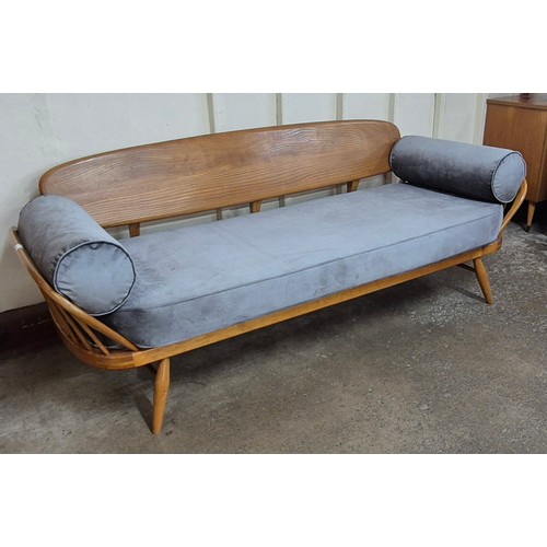 15 - An Ercol Blonde elm and beech 355 model studio couch. Please note this lot is being sold as a work o... 