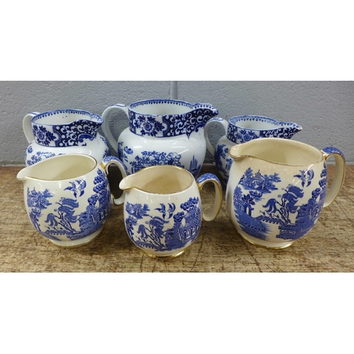 1065 - Two graduated sets of three blue and white jugs, Sadler and Green & Co **PLEASE NOTE THIS LOT IS NOT... 