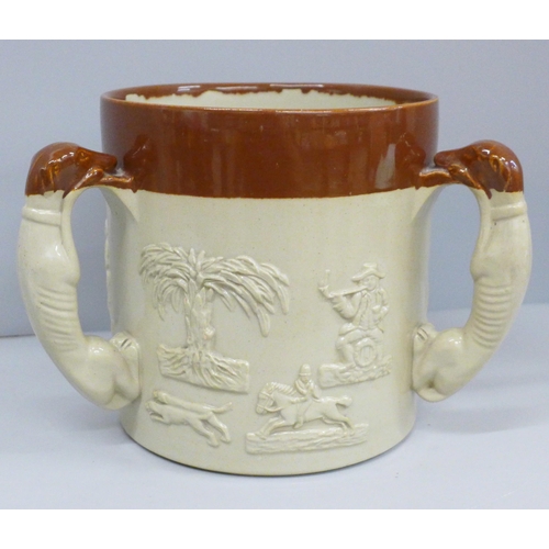 607 - A salt glazed stoneware ale tyg, in relief, with three greyhound handles, 16cm