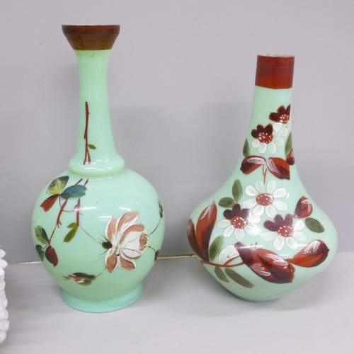 619 - Two ceramic baskets of fruit, both a/f and two opaline green glass vases