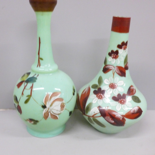 619 - Two ceramic baskets of fruit, both a/f and two opaline green glass vases