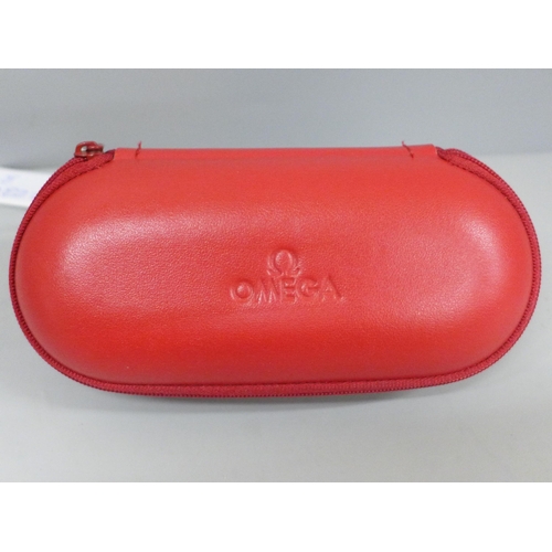 634 - A red Omega travel pouch