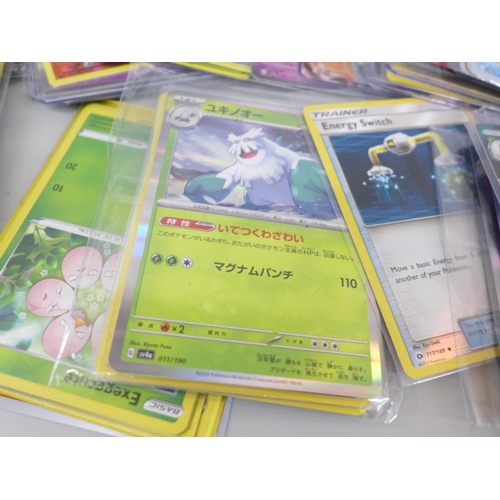 643 - A collection of Pokemon cards including V, holographic, Japanese cards, etc.