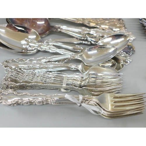 668 - A decorative cutlery set - twelve soup spoons, twelve dessert spoons, seven knives, twelve forks, el... 