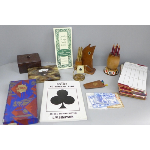 683 - A collection of bridge items including 1930s score cards, bridge markers including one in the form o... 