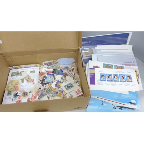 688 - A box of loose stamps, first day covers and a set of Ukraine stamps