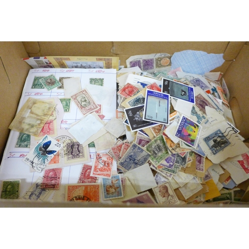 688 - A box of loose stamps, first day covers and a set of Ukraine stamps