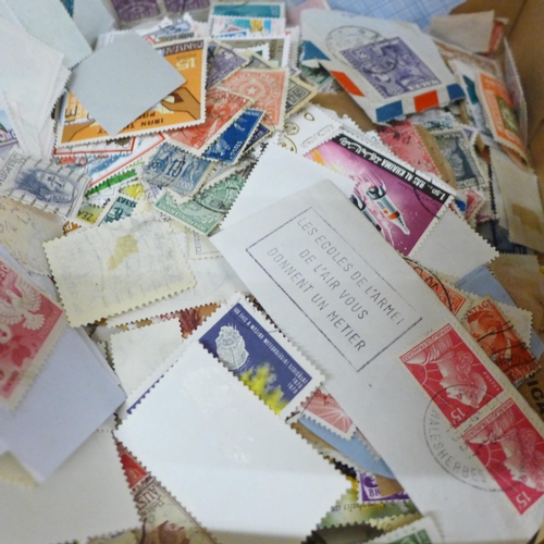 688 - A box of loose stamps, first day covers and a set of Ukraine stamps