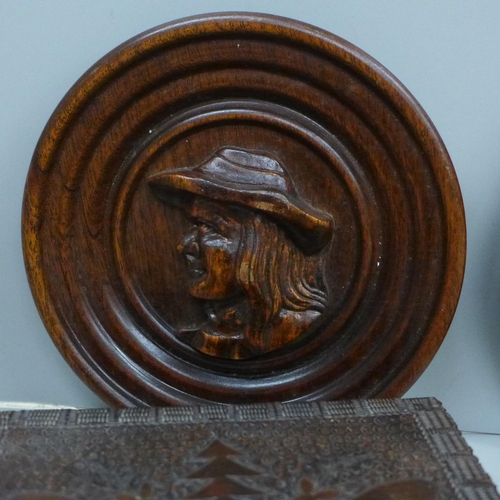 698 - A carved wooden musical box, two other carved wooden boxes and two circular wooden plaques