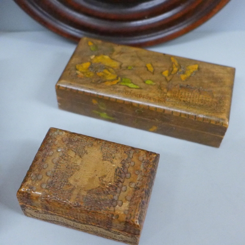 698 - A carved wooden musical box, two other carved wooden boxes and two circular wooden plaques