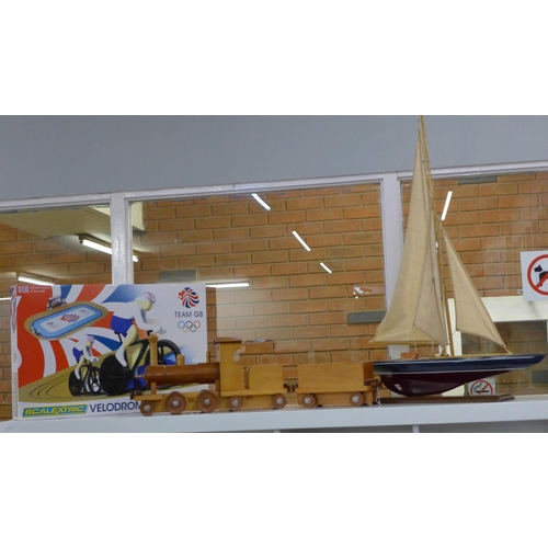 737 - A wooden model of a yacht, a wooden toy train and a Team GB Scalextric Velodrome cycling set