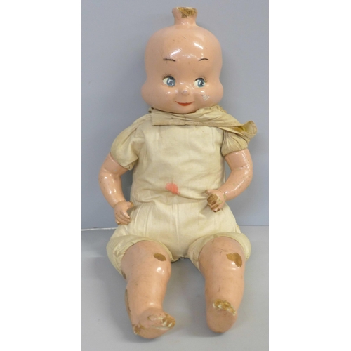 740 - A doll with wooden head and limbs with three faced head and stuffed body