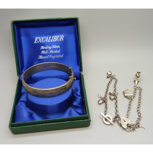 879 - A vintage silver bangle in original box and two silver charm bracelets, 51g